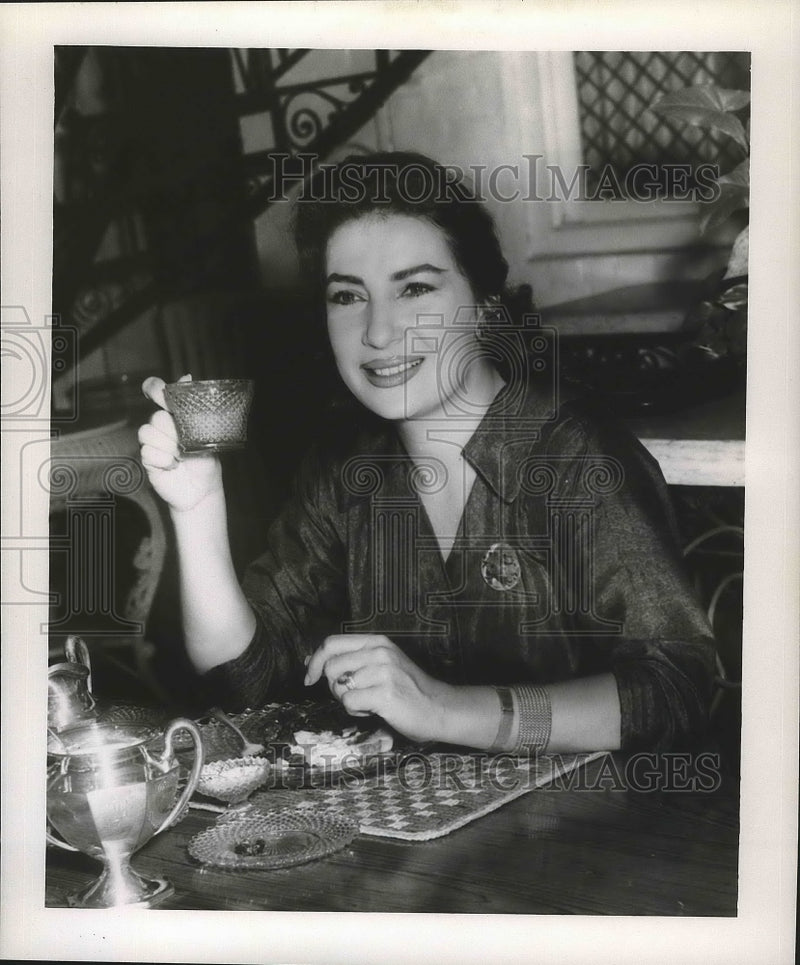 Load image into Gallery viewer, 1958 Press Photo Contralto Opera Singer Belen Amparan drinks tea - nox01935
