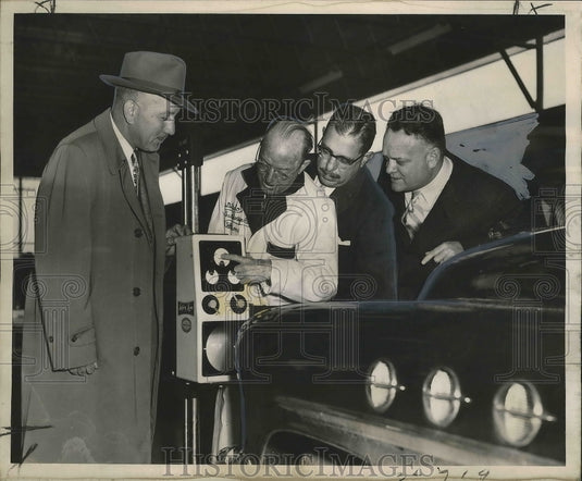 1953 Press Photo Men watch operation of station's headlight-checking machine- Historic Images