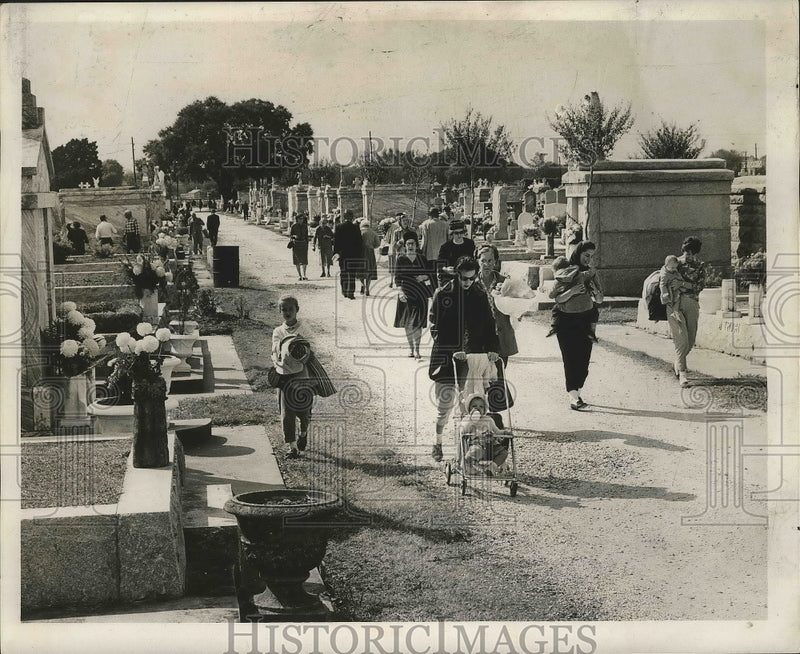 Load image into Gallery viewer, 1962 Press Photo People walk along graves at Metairie Cemetery on All Saints Day
