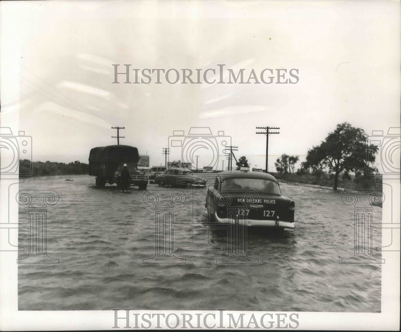 Load image into Gallery viewer, 1956 Press Photo Hurricane Flossy - New Orleans Police drive through flood water
