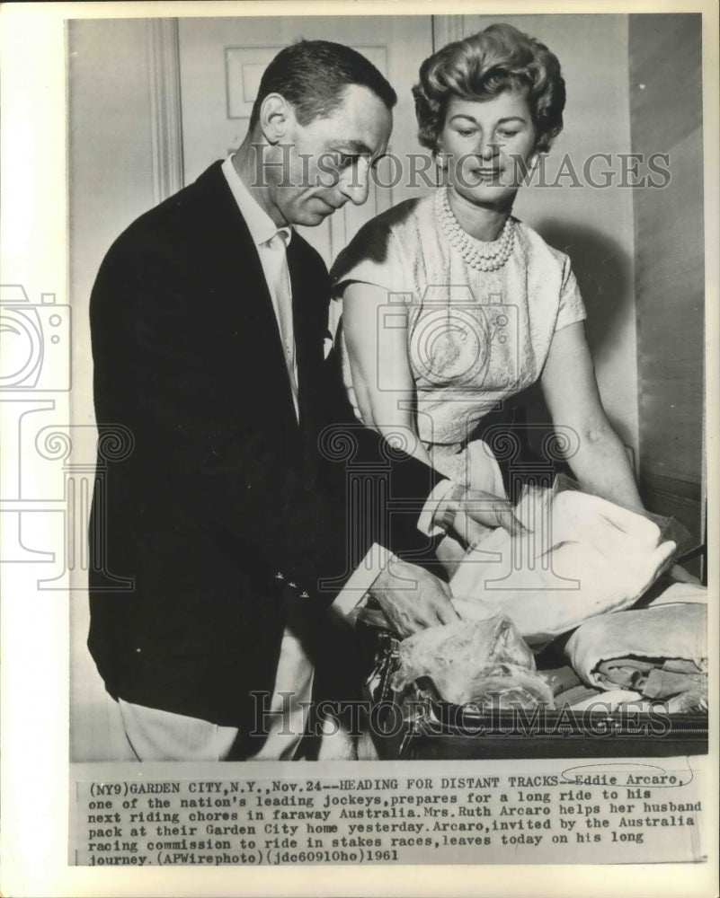 1961 Press Photo Jockey Eddie Arcaro and wife, Ruth, prepare for Australia trip.- Historic Images