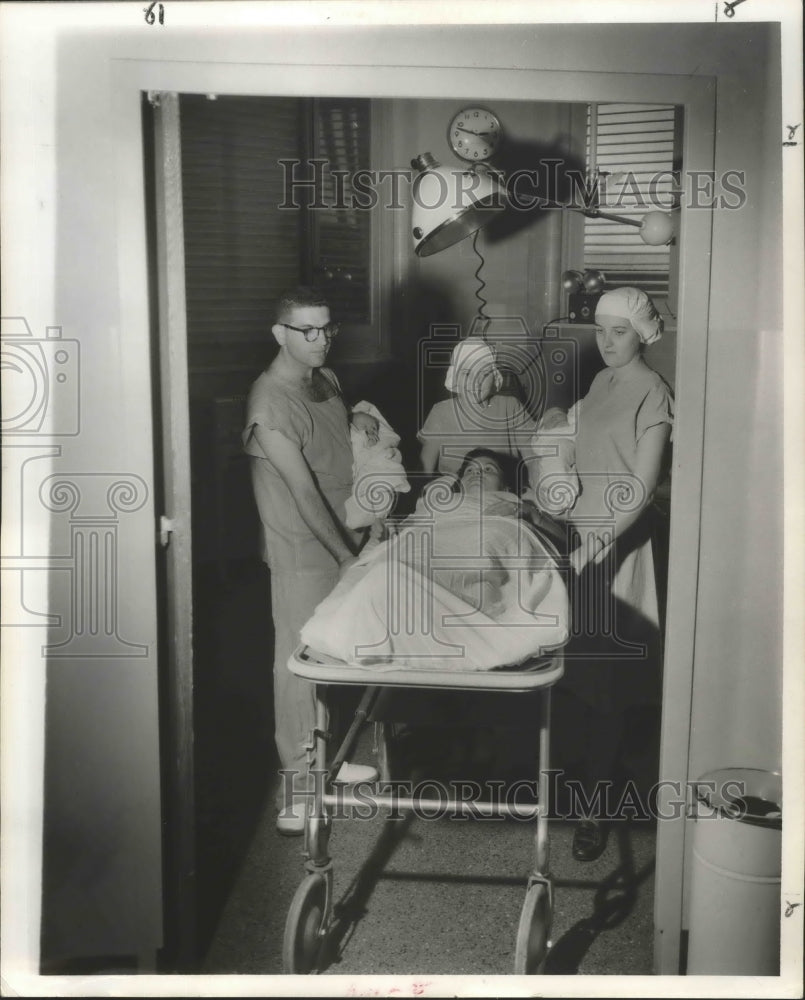 1957 Press Photo A mother and twins leaves delivery room with Dr. E. Ralph Lupin