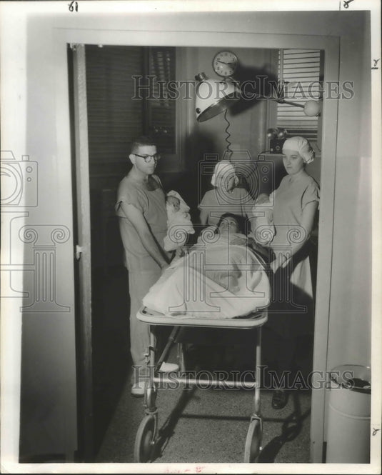 1957 Press Photo A mother and twins leaves delivery room with Dr. E. Ralph Lupin