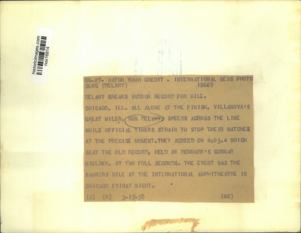 1958 Press Photo Ron Delany speeds across Finish Line and Officials track Time