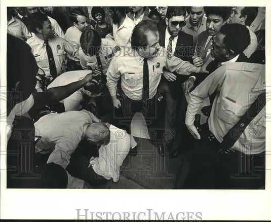 1984 Press Photo Police officers calm a crowd while arresting Pat Bryant