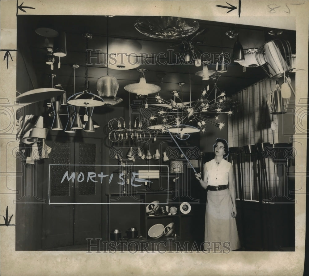 1954 Press Photo Pat Lambert at Electrical Supply Co.&#39;s light fixtures gallery