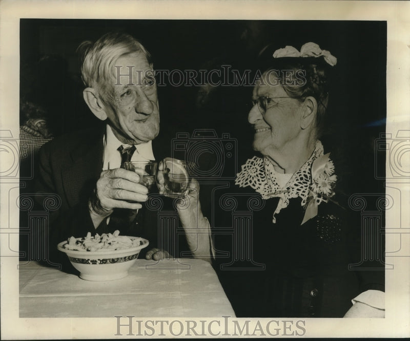 Load image into Gallery viewer, 1949 Press Photo Mr. &amp; Mrs. Louis Fraiche toast at Golden Age "Night Club"
