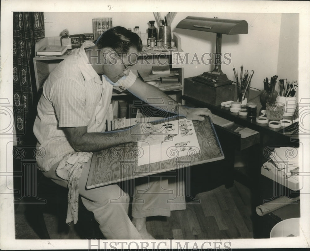 1954 Press Photo Artist Phillip Gray at work, drawings help illiterate to read
