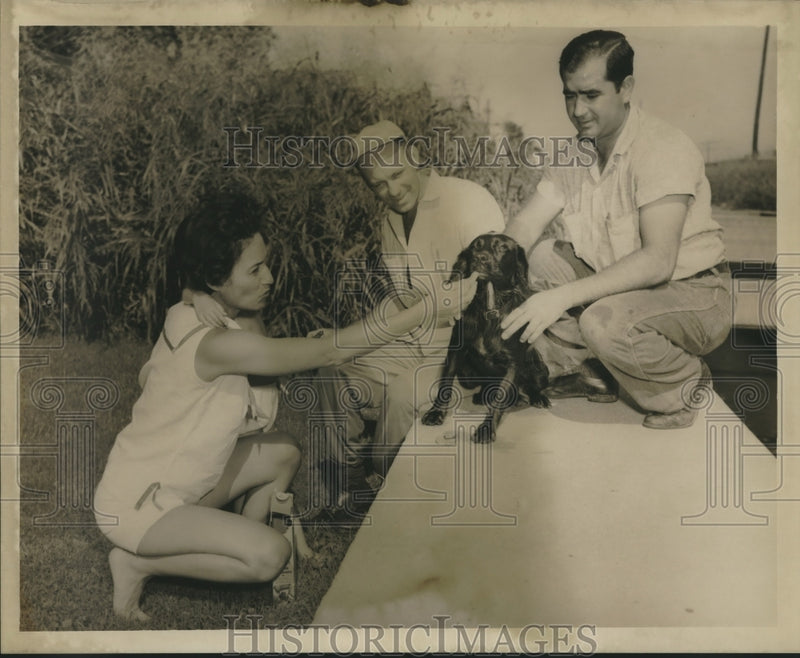 Load image into Gallery viewer, 1959 Press Photo Mrs. Louis Henry of 3015 Conti, New Orleans, with two men, dog
