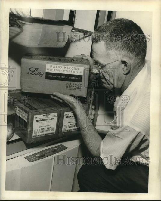 1957 Press Photo Jack Morse checking Polio vaccine supplies in his refrigerator