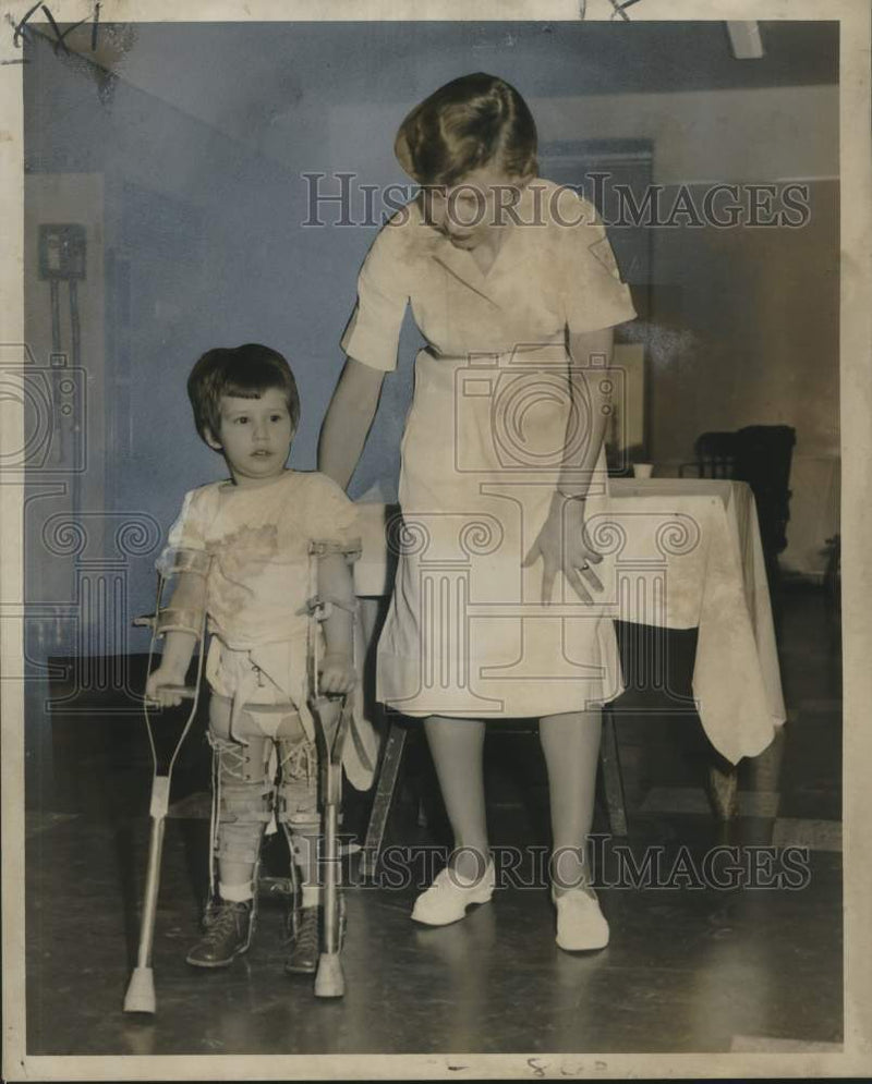 Load image into Gallery viewer, 1958 Press Photo Debra Trahan is assisted in walking by Miss Isadore Brown
