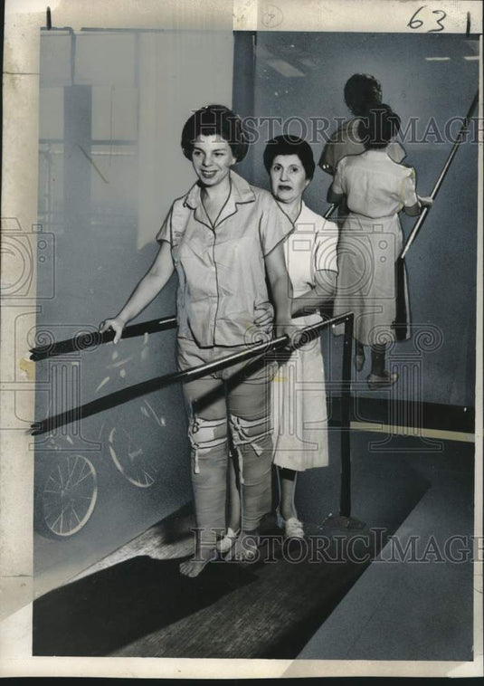 1955 Press Photo Polio Victim learning to walk again with assistance from woman
