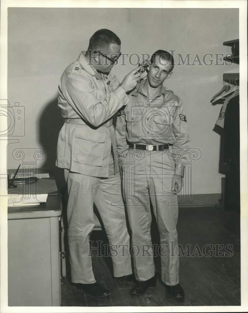 1958 Press Photo Surgeon Examines Airman First Class Archie A. Rodriguez Jr.