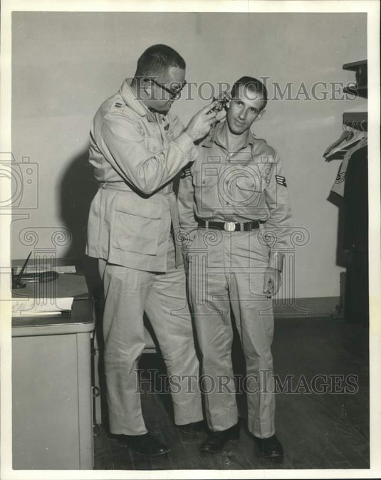 1958 Press Photo Surgeon Examines Airman First Class Archie A. Rodriguez Jr.