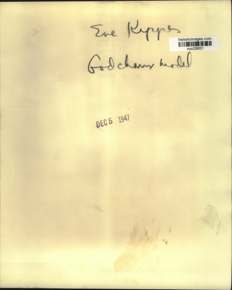 1947 Press Photo Eve Kippes models evening wear in front of a Christmas tree