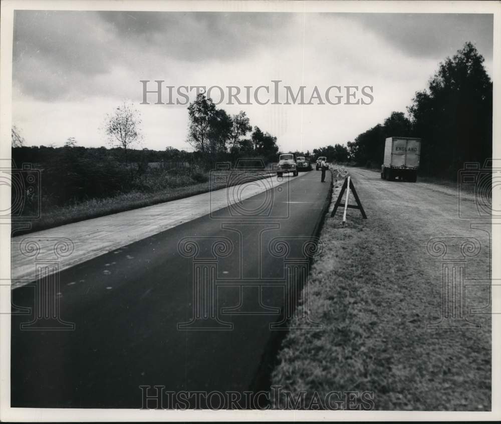 1952 Press Photo Construction crews put asphalt over concrete on the road
