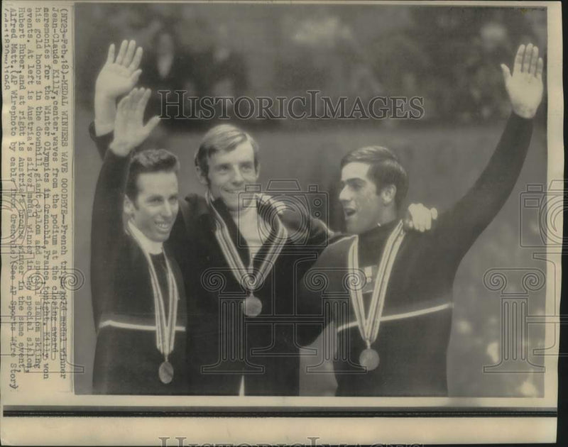 Load image into Gallery viewer, 1968 Press Photo Gold, Silver &amp; Bronze Medalist Skiers Wave from Podium
