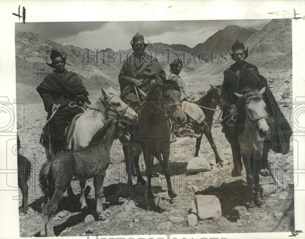 1962 Press Photo Monks travel by horseback across the inhospitable land.