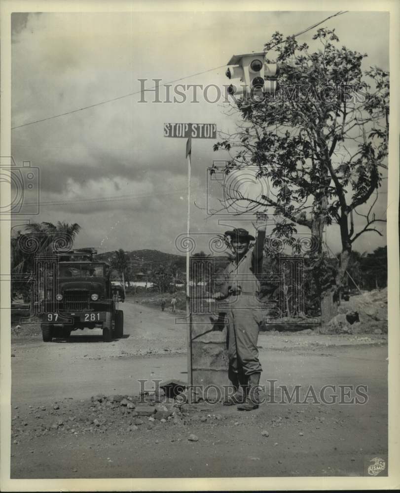 1945 Press Photo U.S. Marine Stanford Optowsky Directs &quot;Traffic&quot; in Saipan