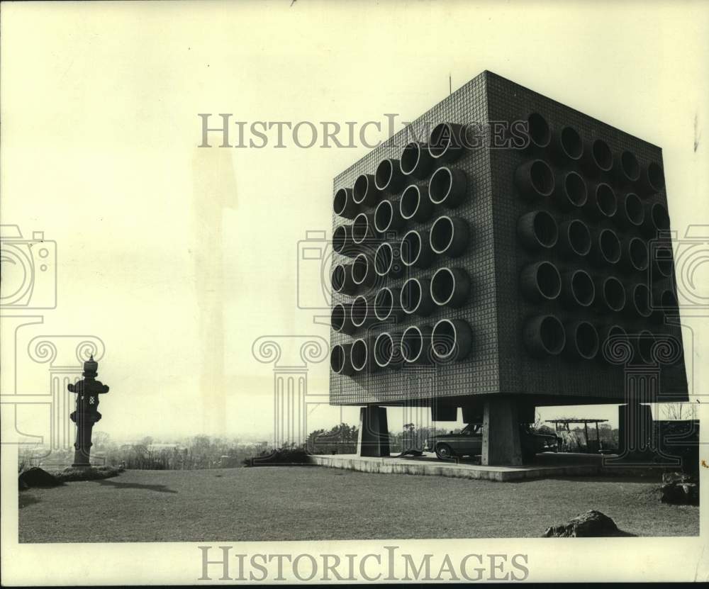 1970 Press Photo A car parked under a unique apartment building made of steel