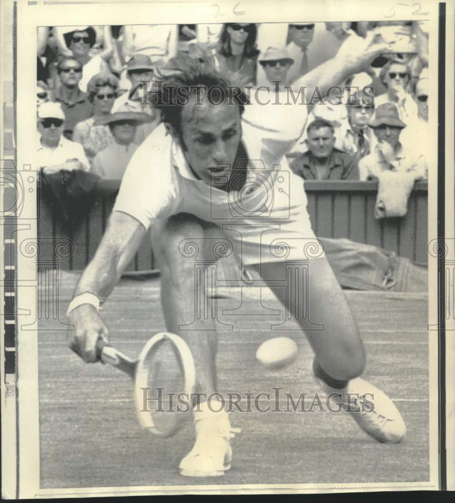 1969 Press Photo John Newcombe, shown stretching for a low return at Wimbledon.- Historic Images