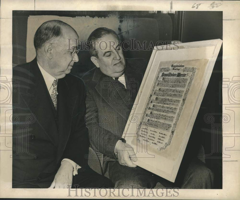 Load image into Gallery viewer, 1951 Press Photo A.T. Mercier &amp; Donald Russell look at certificate for Mercier
