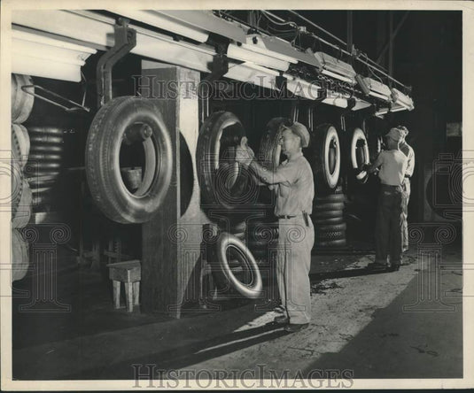 1951 Press Photo Armstrong Tire & Rubber employee scraping off rubber tips.