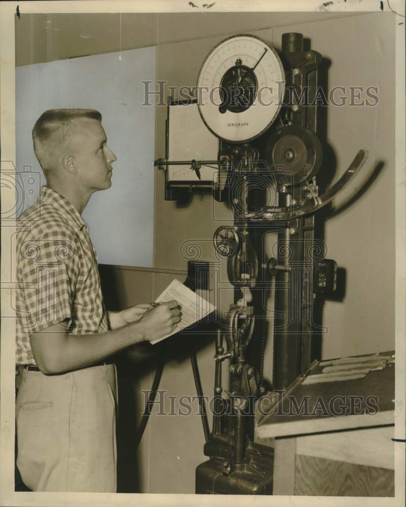 1959 Press Photo Gary J. Steen Tests Ironing Board Cover Fabric - nox40511