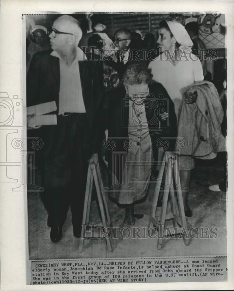 1965 Press Photo Disabled Cuban Refugee Helped Ashore in Key West - nox40965