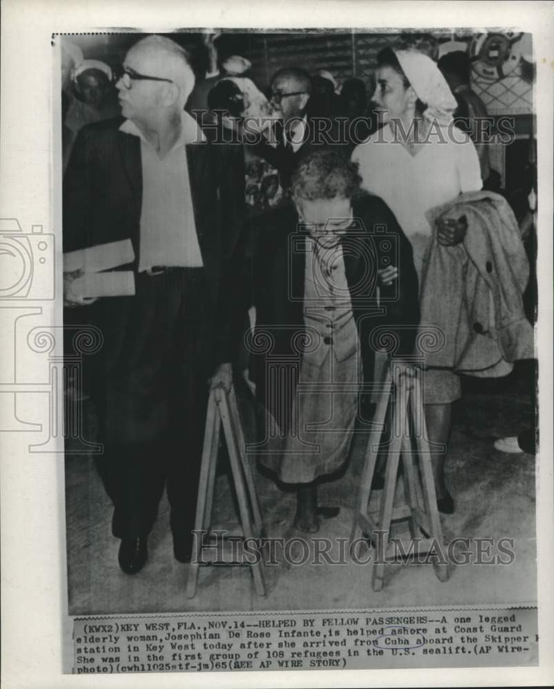 Load image into Gallery viewer, 1965 Press Photo Disabled Cuban Refugee Helped Ashore in Key West - nox40965
