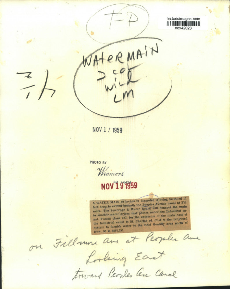 1959 Press Photo A water main is installed below the Peoples Ave. canal, Filmore