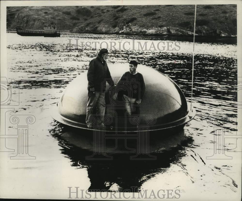 1968 Press Photo Workmen inspect a shipwreck capsule after a test launch- Historic Images