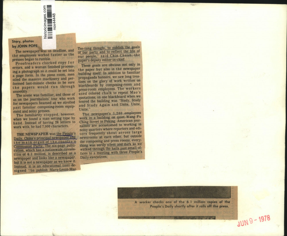 1978 Press Photo Worker checks a copy of People's Daily in China - nox44448