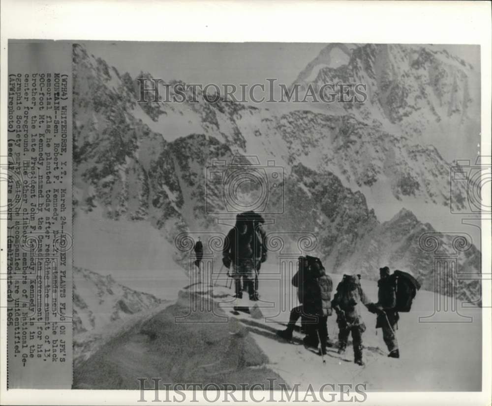 1965 Press Photo Robert Kennedy plants memorial flag at Canada's Mt. Kennedy.- Historic Images