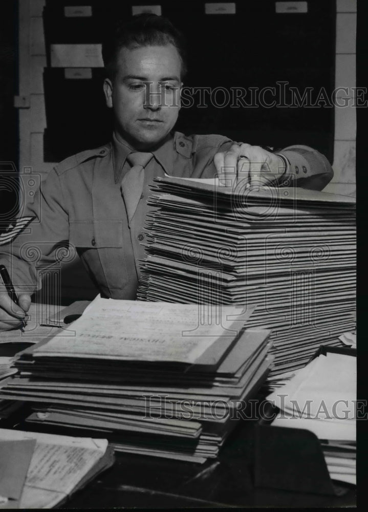 1951 Press Photo M/Sgt. Jack Barden Peers Mournfully Over Mountain of Paper Work- Historic Images