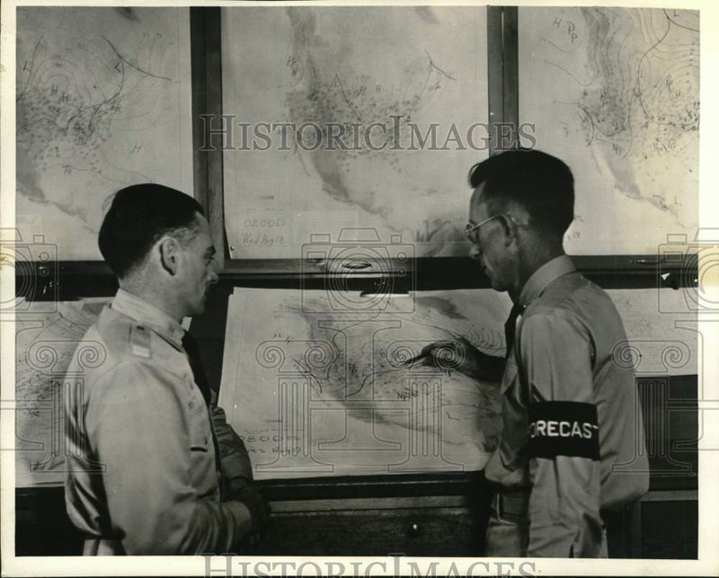 Load image into Gallery viewer, Press Photo Army pilot &amp; official forecaster, weather charts - pim01782
