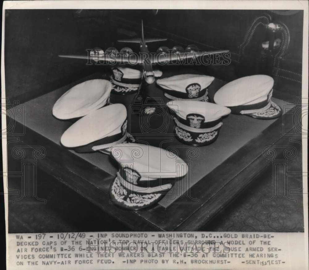 1949 Press Photo Air Force's B-36 model & Naval officer caps, Washington, D.C.- Historic Images