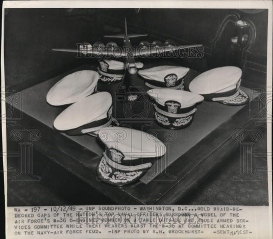 1949 Press Photo Air Force's B-36 model & Naval officer caps, Washington, D.C.- Historic Images
