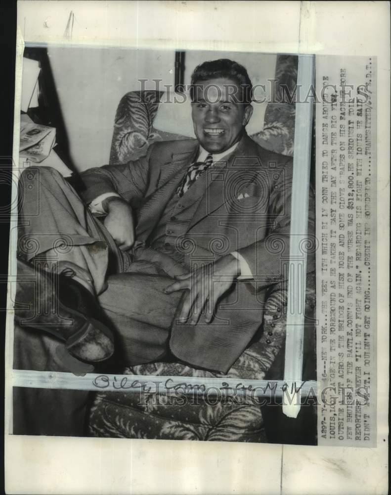 1946 Press Photo Boxer Billy Conn sits comfortably after fight with Joe Louis- Historic Images