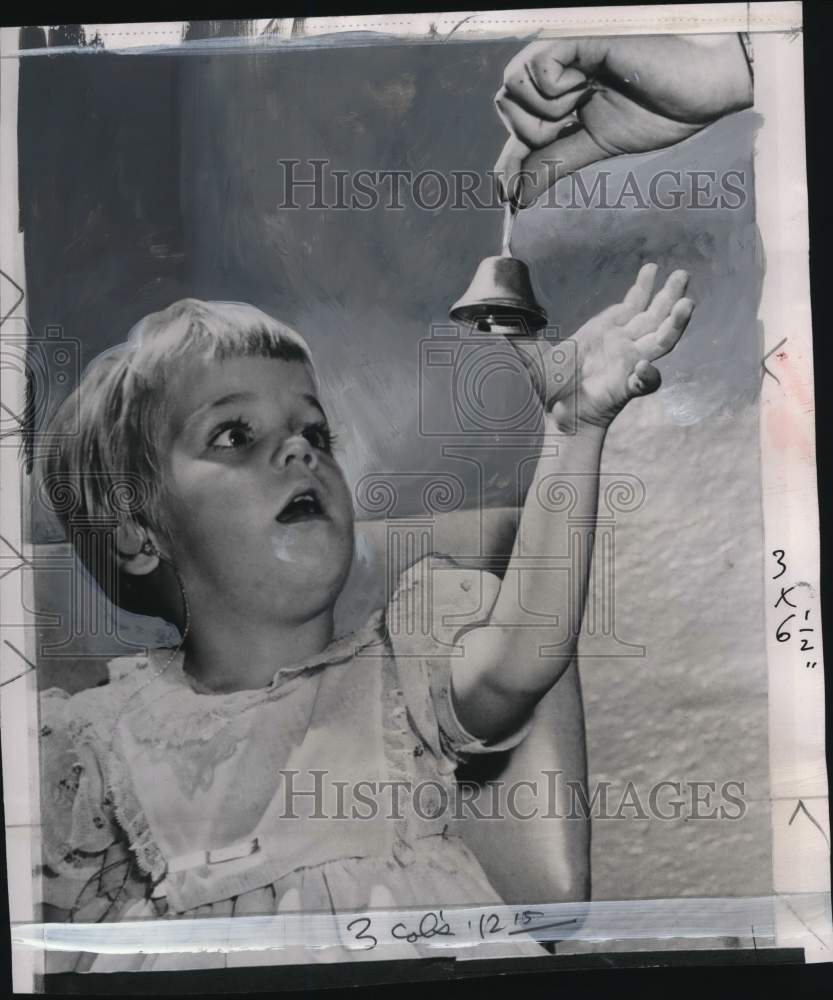 1956 Press Photo Young Lynn Hodapp wears hearing aid & reaches for bell in Ohio- Historic Images
