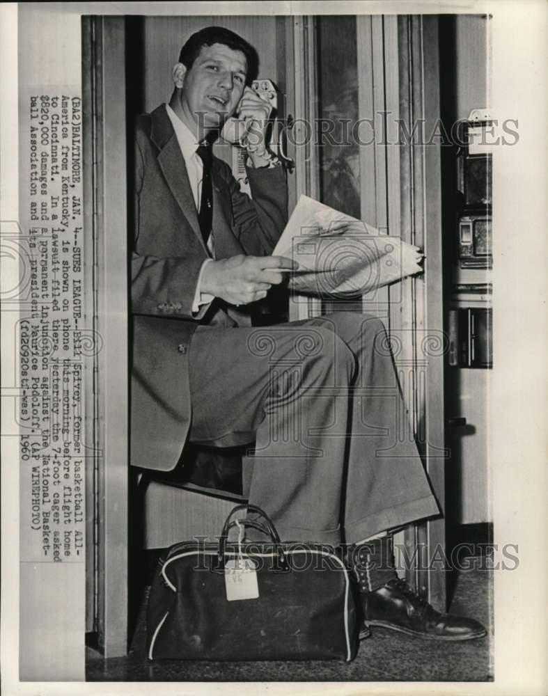 1960 Press Photo Bill Spivey holds newspaper &amp; on phone before flight, Baltimore- Historic Images