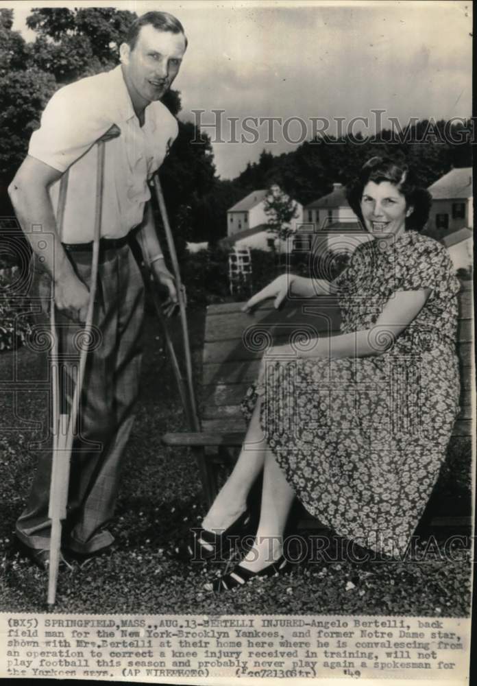 1949 Press Photo Injured Yankee football player Angelo Bertelli with wife, MA- Historic Images