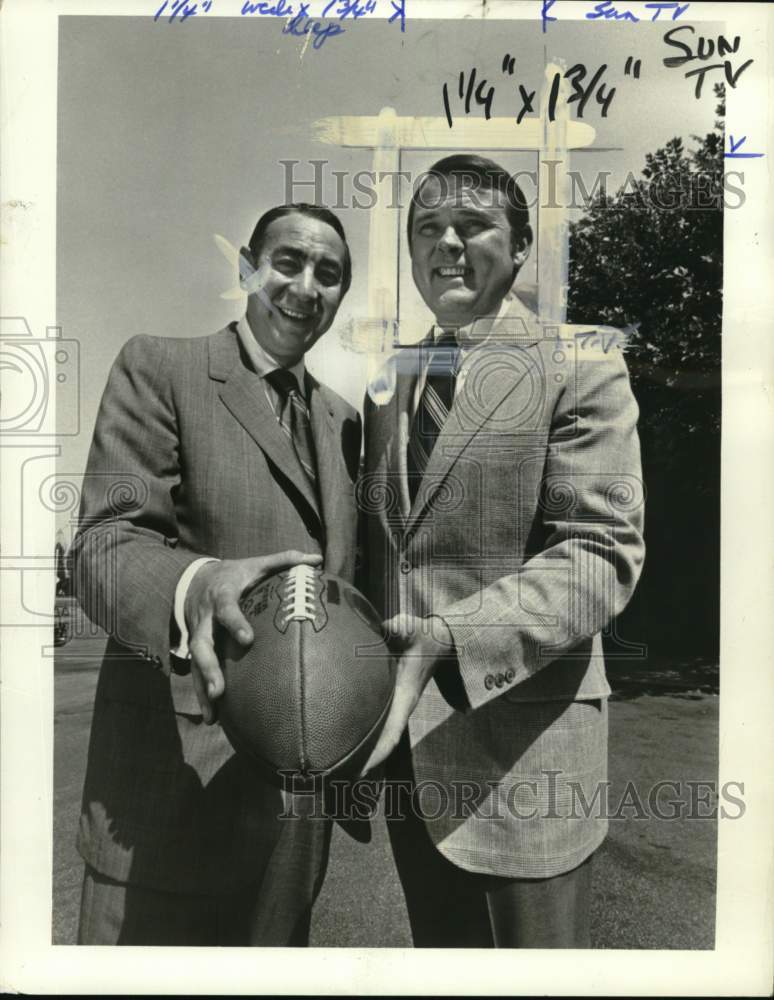1977 Press Photo Sports commentator Keith Jackson holds football with colleague- Historic Images