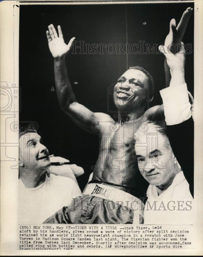 1967 Press Photo Boxer Dick Tiger held up by handlers after bout win, New York- Historic Images