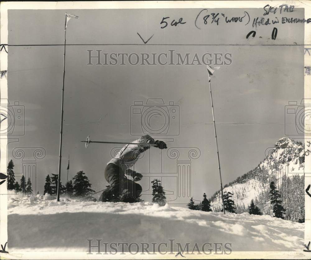 1955 Press Photo Slalom Skier Races Through Gate Near Snow-Covered Mountain Peak- Historic Images