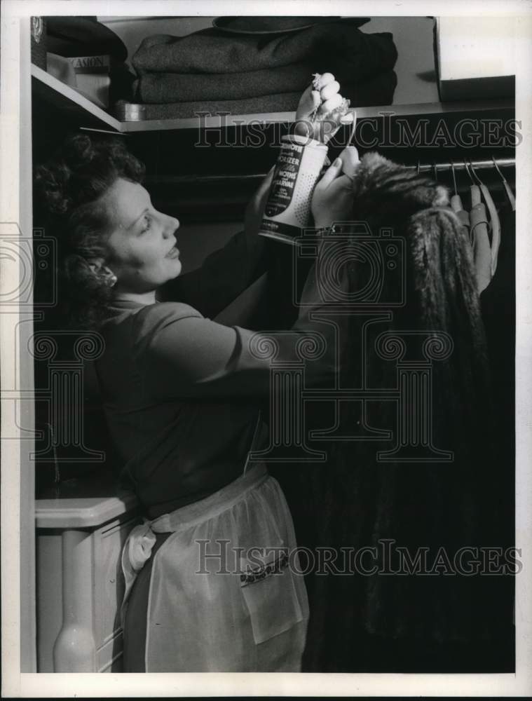1944 Press Photo Woman hangs vaporizer in closet to protect fur coat - piw12787- Historic Images
