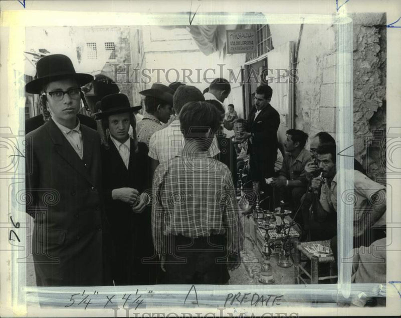 Load image into Gallery viewer, 1967 Press Photo Arabs smoking Narghile draw attention in the street, Jerusalem
