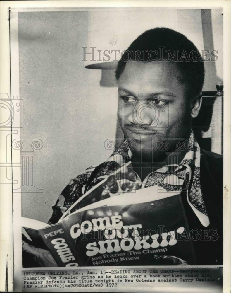 1972 Press Photo Boxer Joe Frazier holding a book of his biography, Louisiana- Historic Images