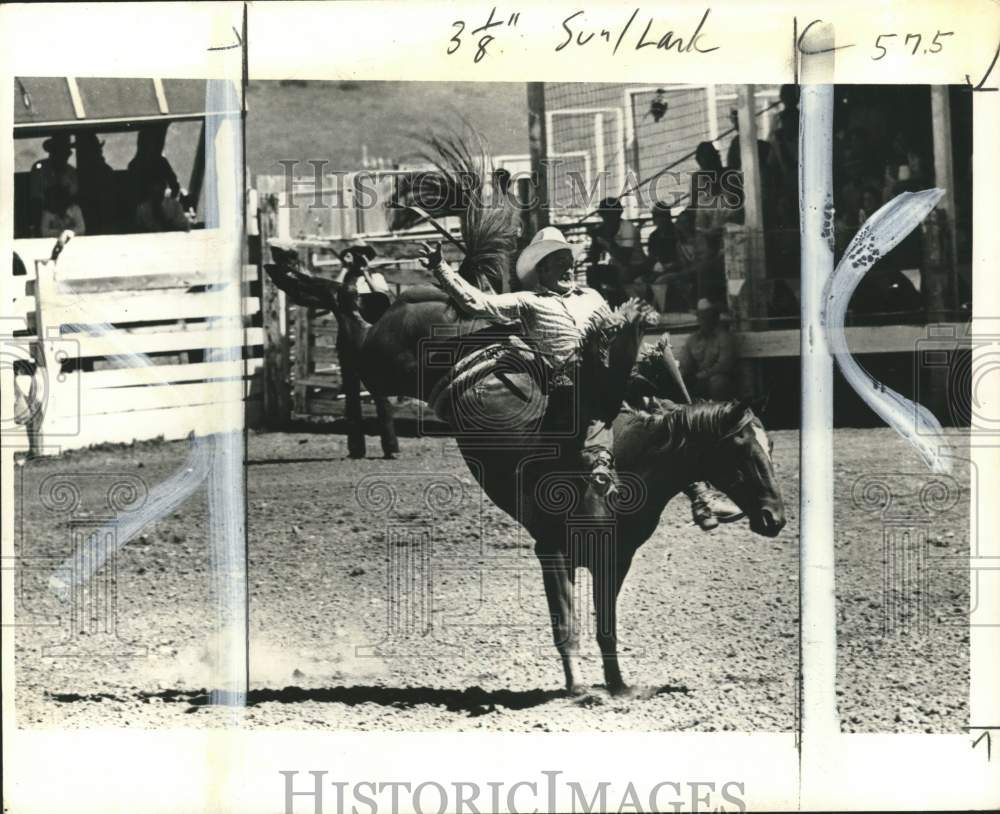 1975 Press Photo Cowboy tries to stay on bucking bronc, Montana - pix09913- Historic Images