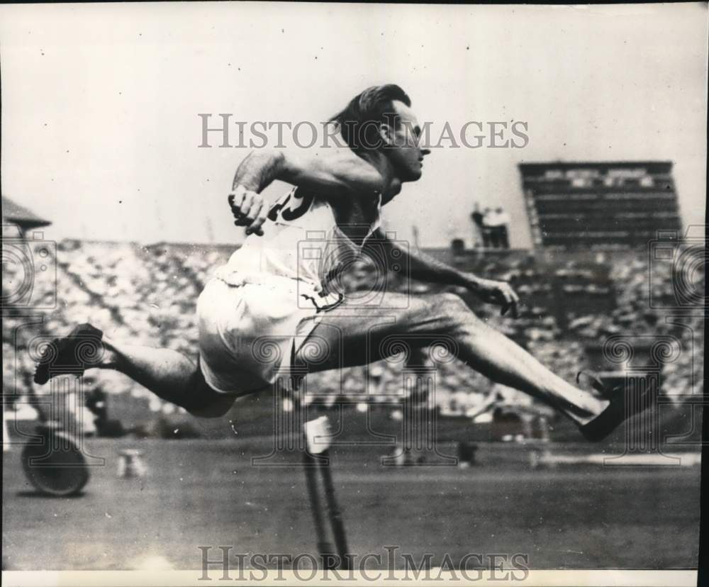 1948 Press Photo Roy Cochran leaps over hurdle, Wembley, England - pix12284- Historic Images